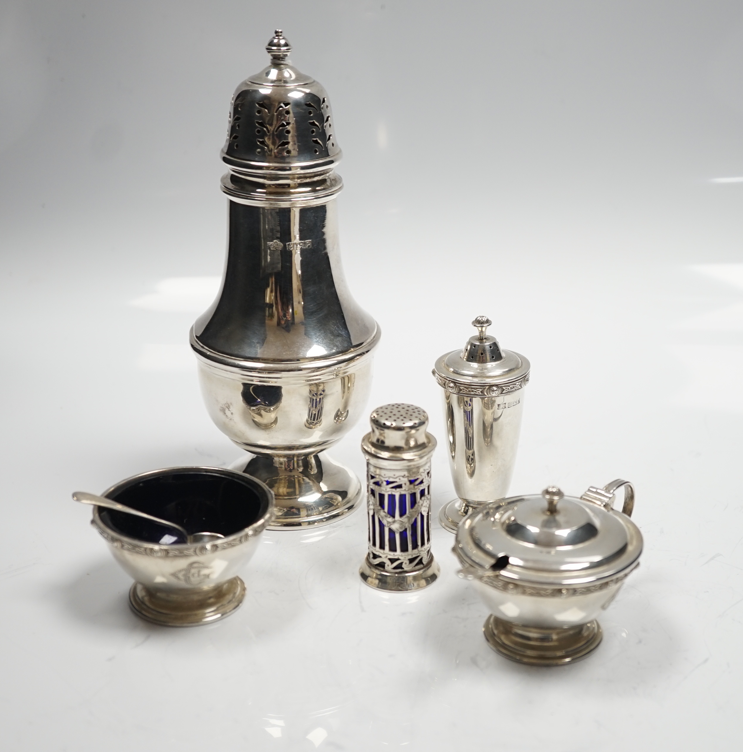 A modern silver baluster sugar caster by Elkington & Co and four assorted silver condiments.